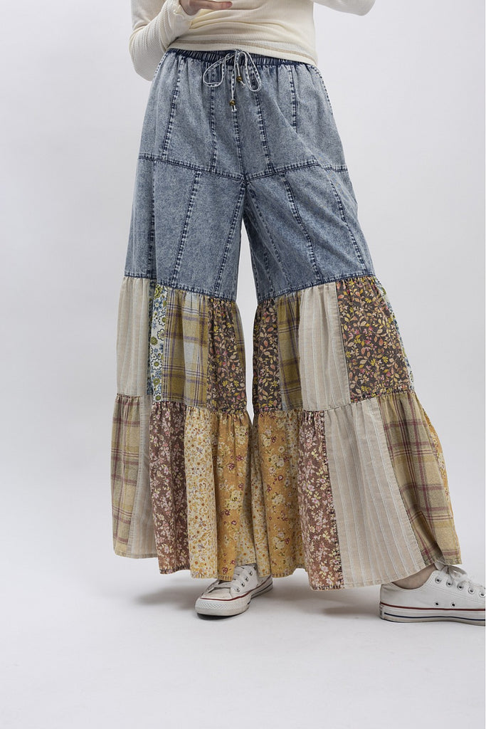 Patchwork wide-leg denim pants with floral, plaid, and striped fabric panels in earthy tones, boho boutique style