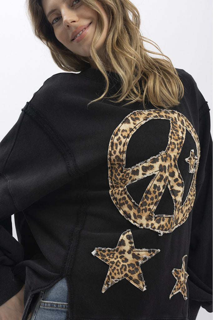 Euphemia leopard peace sign sweatshirt in washed black with a large animal print graphic, a relaxed fit, and distressed raw hem.