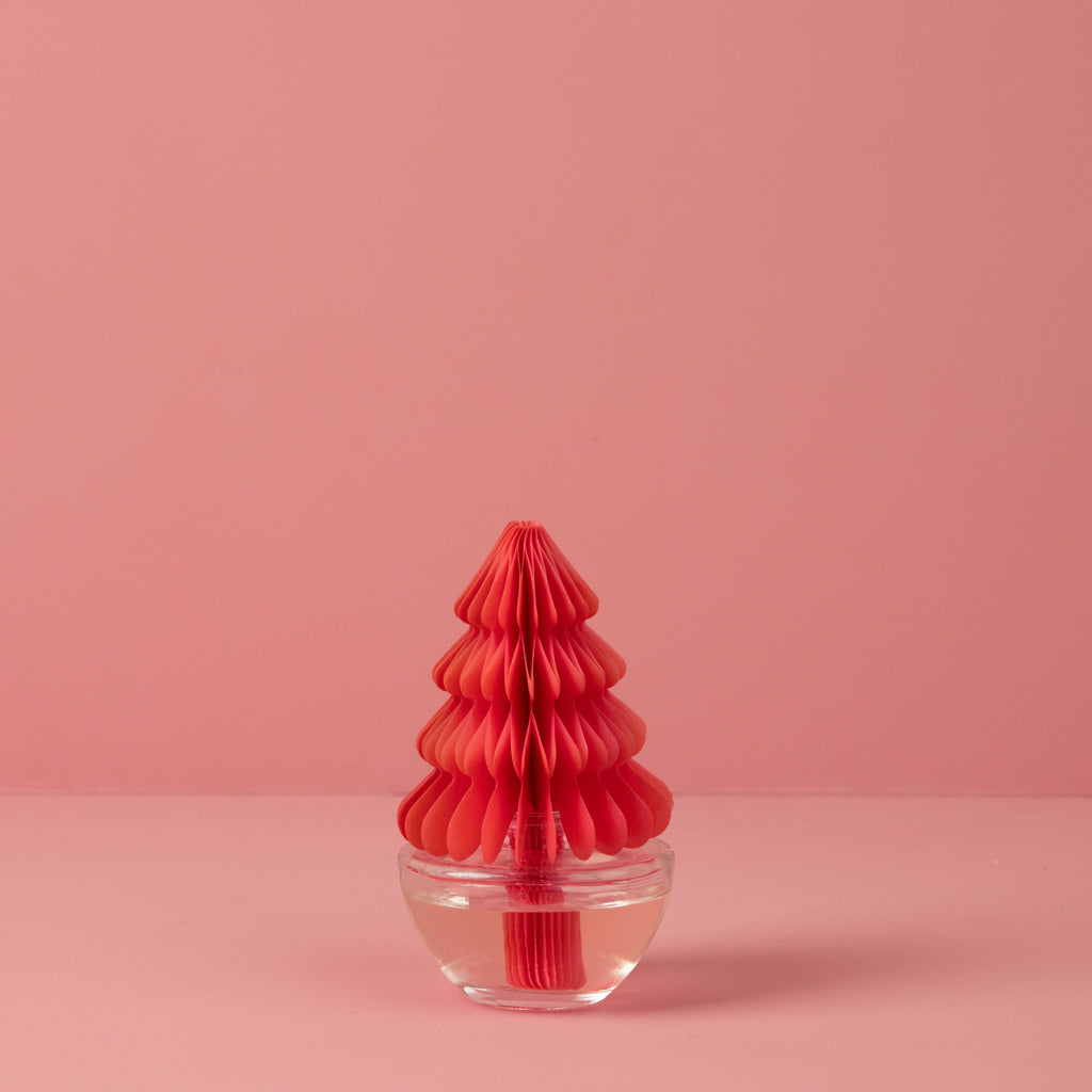 Pink honeycomb Christmas tree diffuser in clear glass base with Sweet Grace packaging.