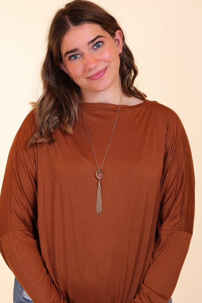 Gold chain necklace featuring a faceted gemstone pendant and cascading gold tassel accent.