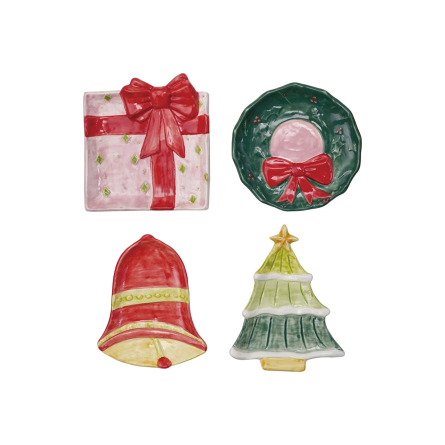 Four hand-painted stoneware holiday dishes in shapes of a gift box, wreath, bell, and Christmas tree, sold individually.