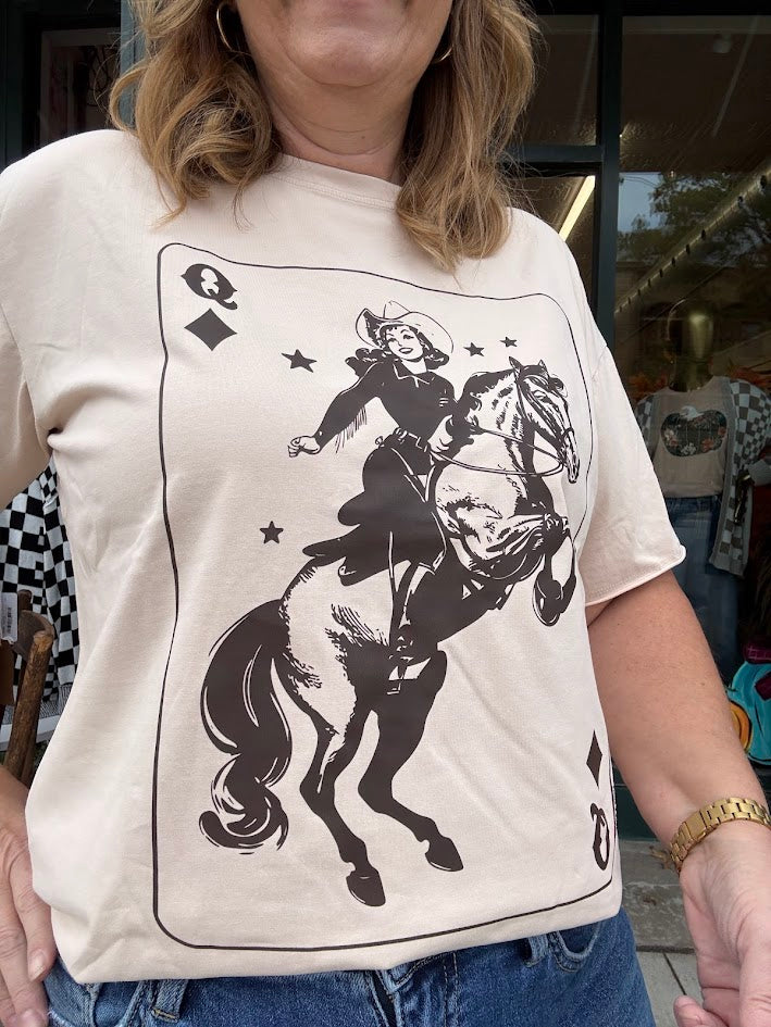 Person wearing a t-shirt with a graphic of a cowboy on a horse