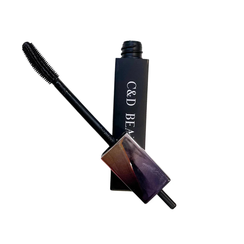 Curler and brush with C&D Beauty branding on a white background
