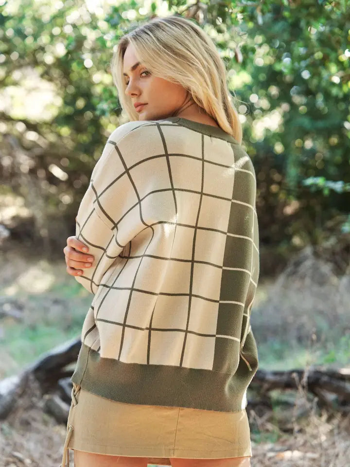 Olive and cream plaid grid knit sweater with crew neckline, long sleeves, and relaxed fit