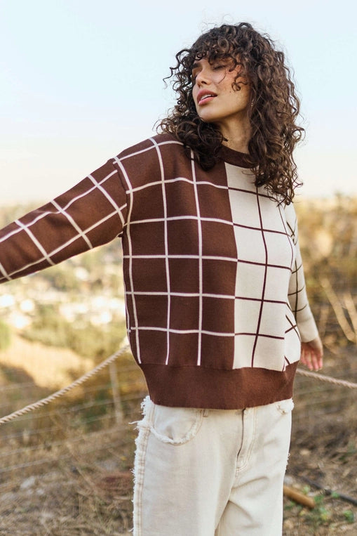 Brown and cream plaid grid knit sweater with crew neckline, long sleeves, and relaxed fit