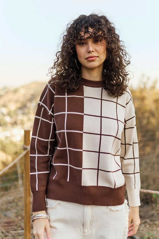 Brown and cream plaid grid knit sweater with crew neckline, long sleeves, and relaxed fit