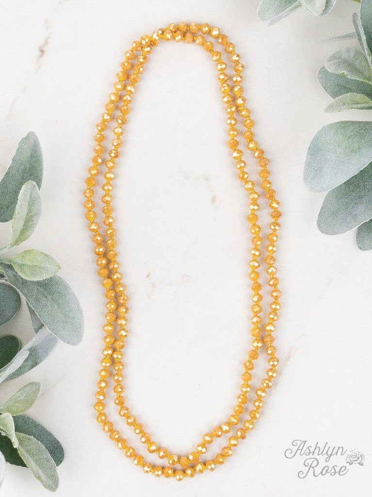 Mustard yellow 60-inch faceted beaded necklace styled in double wrap design.