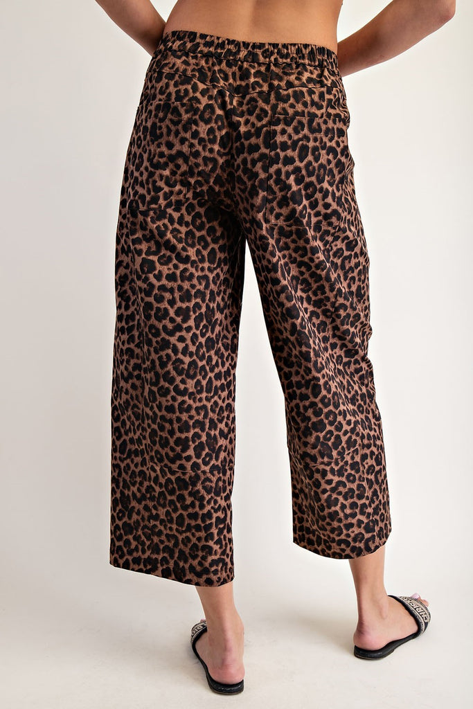 Leopard print pants worn by a person on a plain background