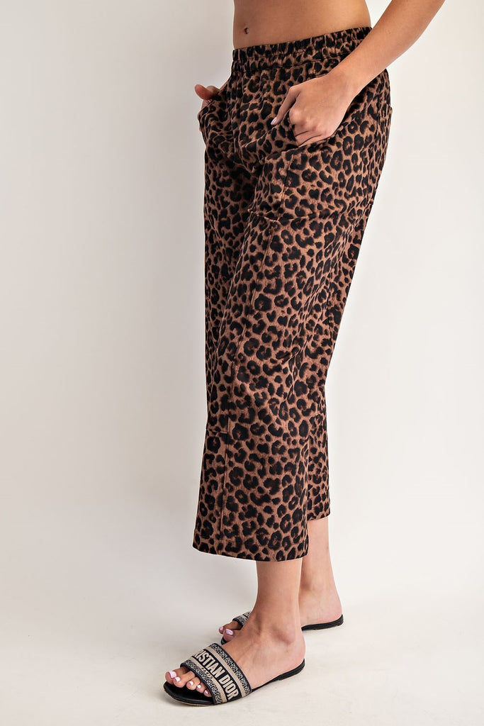 Leopard print pants worn by a person on a plain background