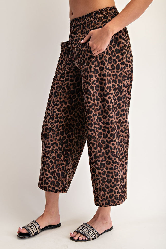 Leopard print pants worn by a person on a plain background