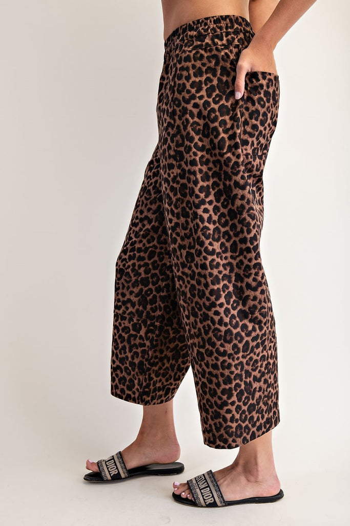 Leopard print pants worn by a person on a plain background