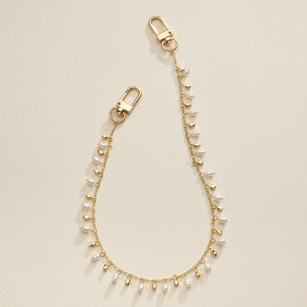 Gold chain bag charm strap with alternating faux pearl and gold drop accents and dual clasps.