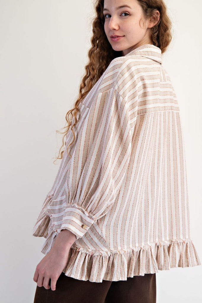 A mushroom-colored linen shirt with vertical white and red stripes. It has a collar, button-down front, long sleeves, and a ruffled hem.