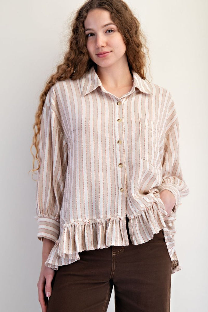 A mushroom-colored linen shirt with vertical white and red stripes. It has a collar, button-down front, long sleeves, and a ruffled hem.