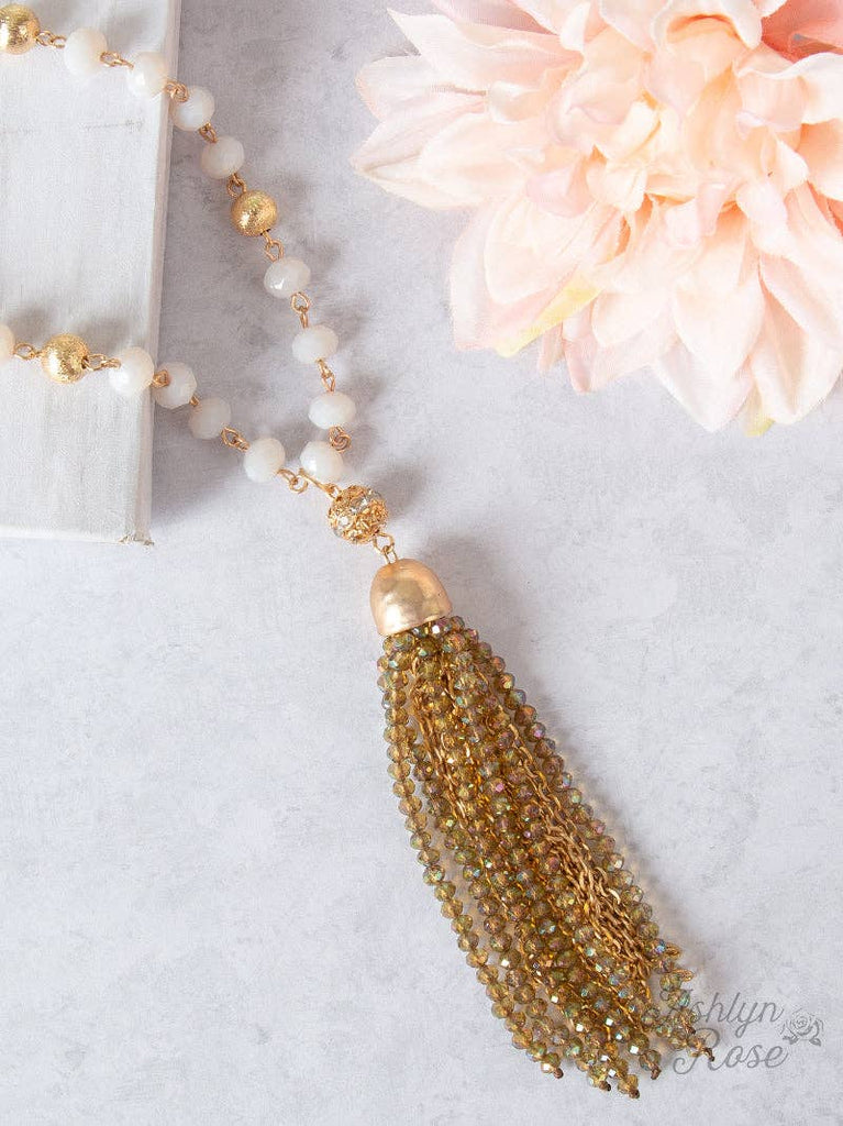 Sage and gold beaded necklace with crystal tassel pendant.