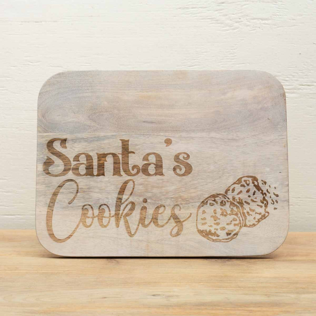 Santa’s Cookies Serving Board made of natural wood with engraved lettering and cookie design, rustic Christmas kitchen accent.