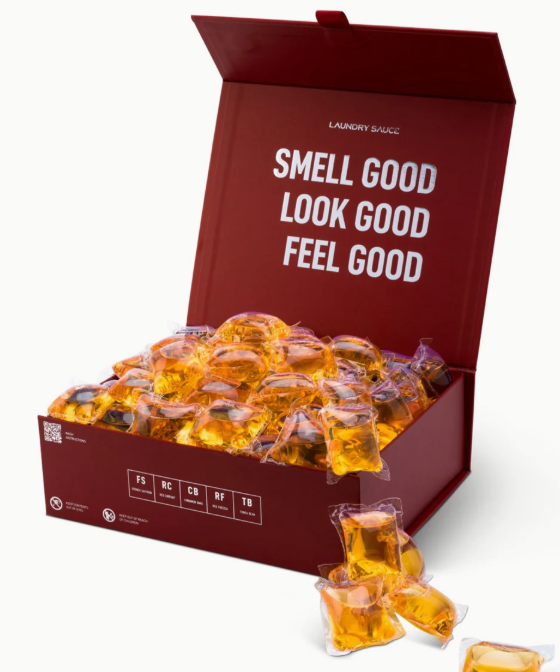 Box of orange gummy bears with a red lid featuring text, on a white background