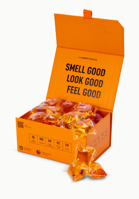 Orange box of LaMour Sauce with text 'Smell Good, Look Good, Feel Good' on a white background