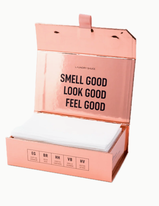 Pink packaging of laundry soap with text 'Smell Good, Look Good, Feel Good' on a white background