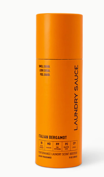 Orange laundry product bottle labeled 'Laundry Sauce' on a white background