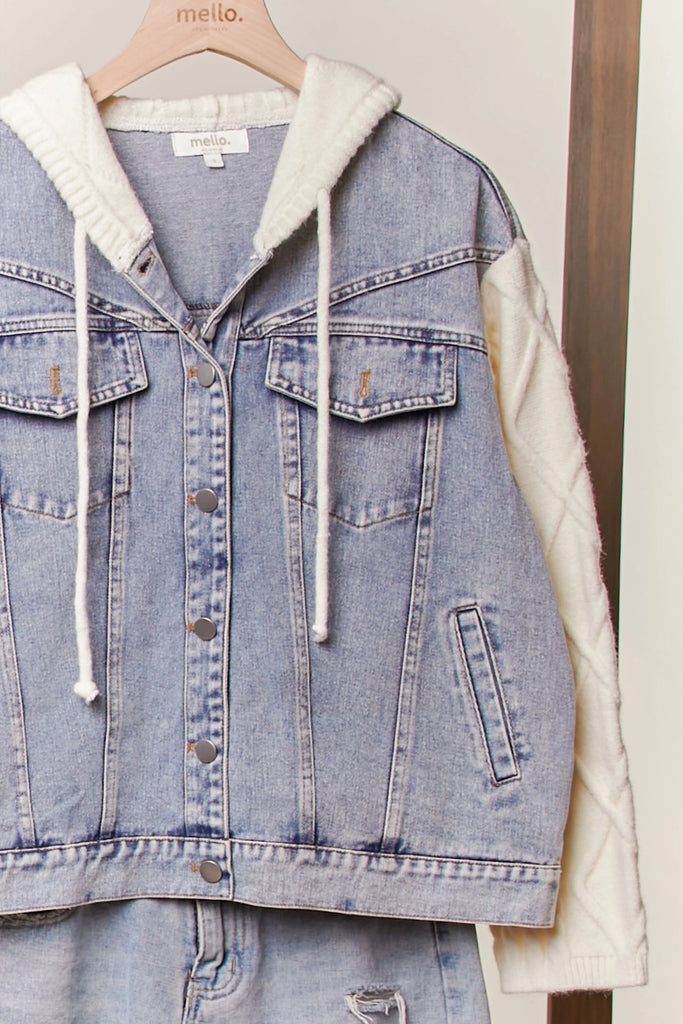 Seraphina knit sleeve denim jacket from Mello, featuring a light wash denim body with an attached knit hood and cream-colored cable-knit sleeves