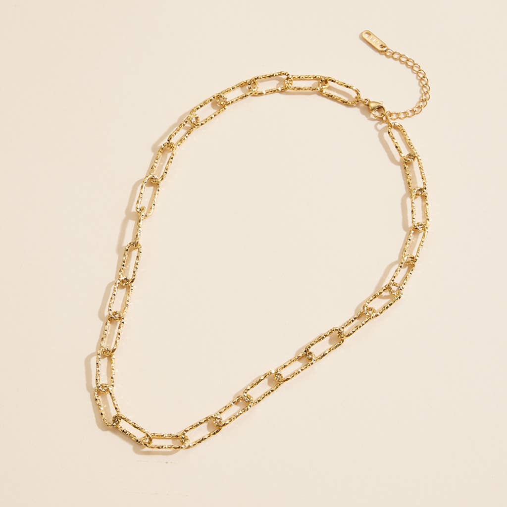 Gold chain linked short necklace with textured links.
