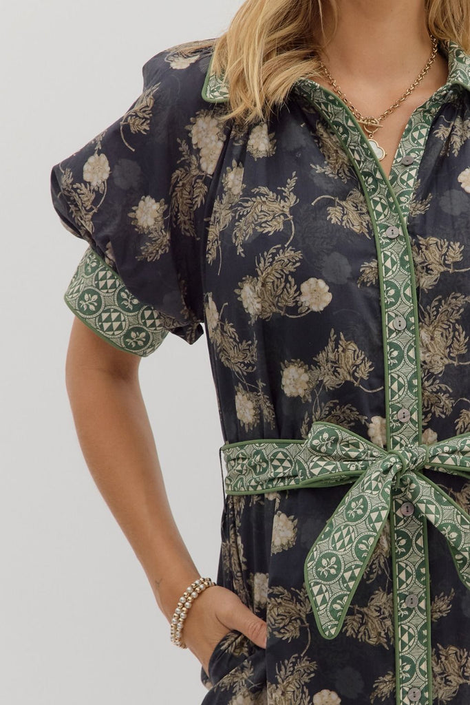 Navy floral midi shirt dress with short puff sleeves, front button closure, removable belt, contrast collar, and side pockets