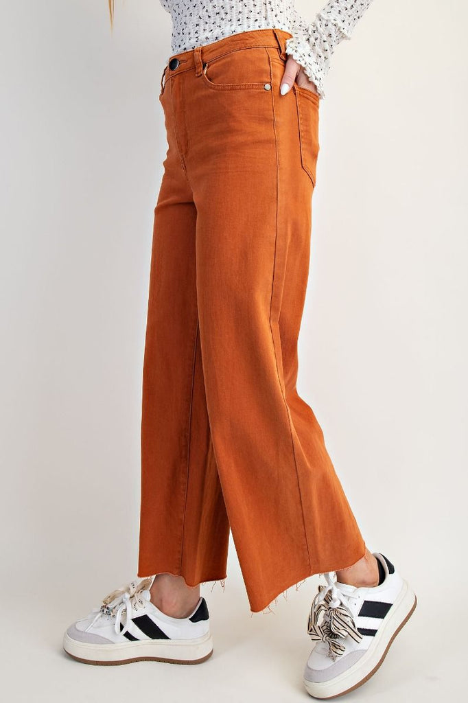 A pair of brick-colored, high-waisted, wide-leg twill pants with a soft stretch.