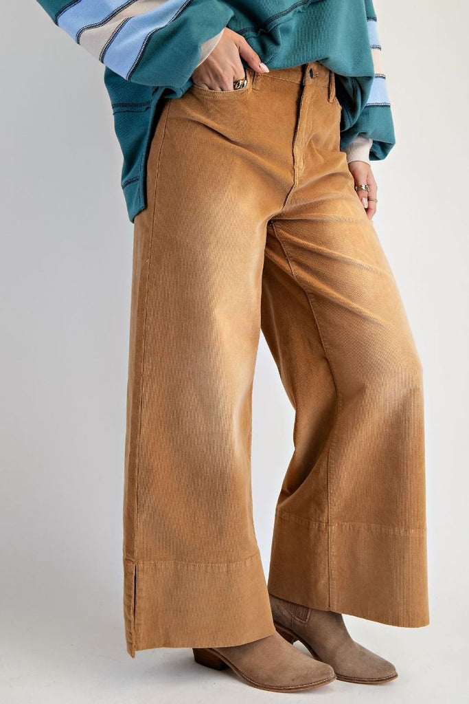 A pair of high-waisted, wide-leg pants in a camel-colored stretch corduroy fabric.