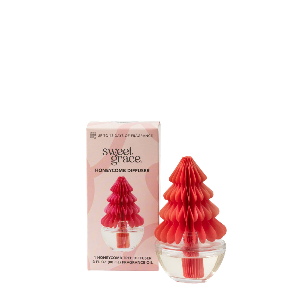 Pink honeycomb Christmas tree diffuser in clear glass base with Sweet Grace packaging.