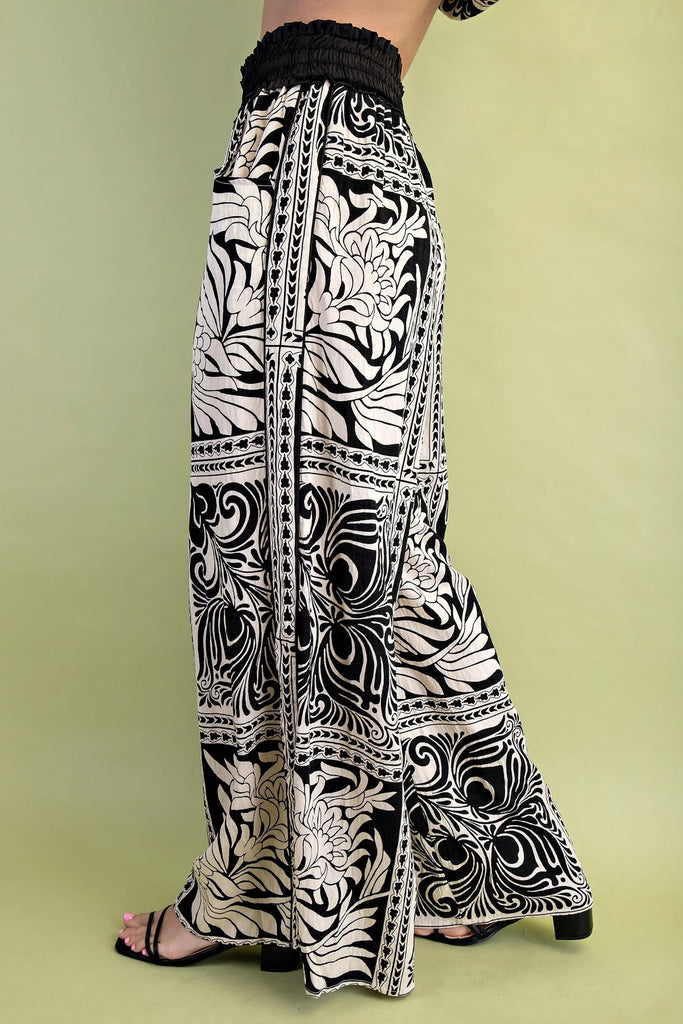 Black and white patterned pants on a green background