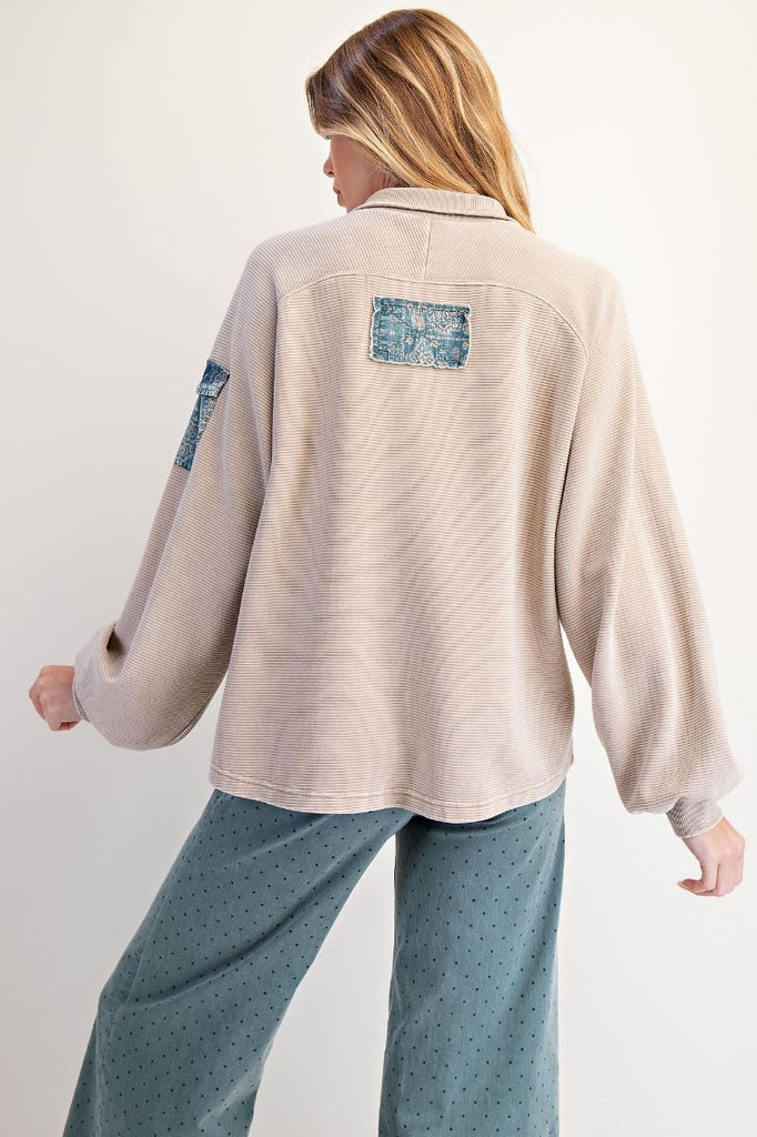 Khaki textured pullover with denim collar, half button placket, and sleeve pocket detail, styled in a relaxed fit boutique casual look.