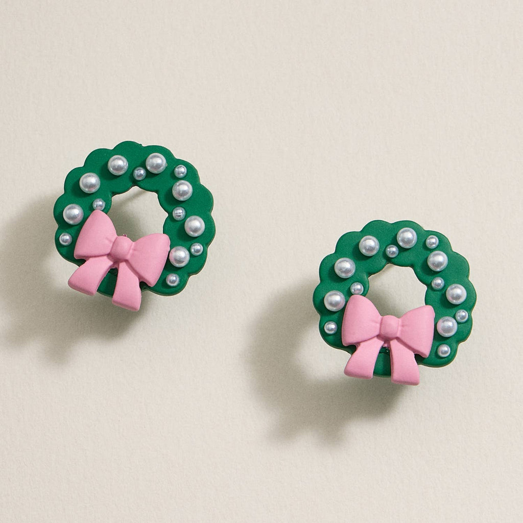 Green enamel Christmas wreath stud earrings with pearl accents and pink bows.