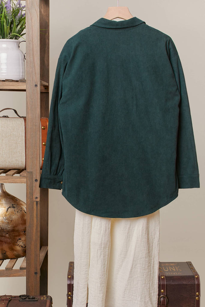 Reversible shacket with red plaid on one side and green corduroy with plaid pockets on the other.