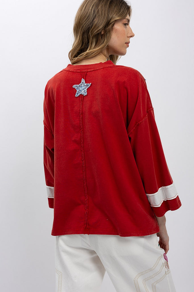 Show your spirit in the Zelia Patchwork Flag T-Shirt. This oversized, distressed red top features a cool, raw-edge flag design. Ships fast from North Missouri!