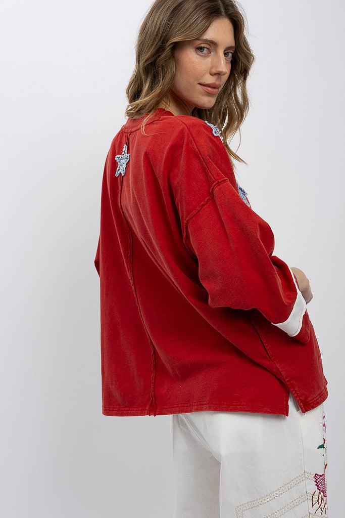 Show your spirit in the Zelia Patchwork Flag T-Shirt. This oversized, distressed red top features a cool, raw-edge flag design. Ships fast from North Missouri!