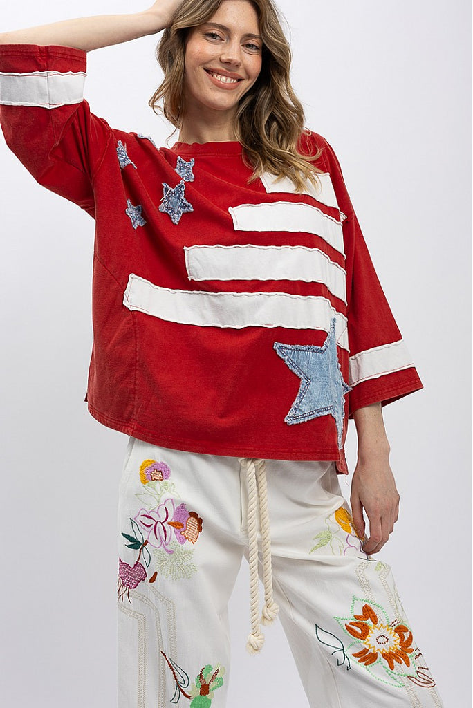Show your spirit in the Zelia Patchwork Flag T-Shirt. This oversized, distressed red top features a cool, raw-edge flag design. Ships fast from North Missouri!
