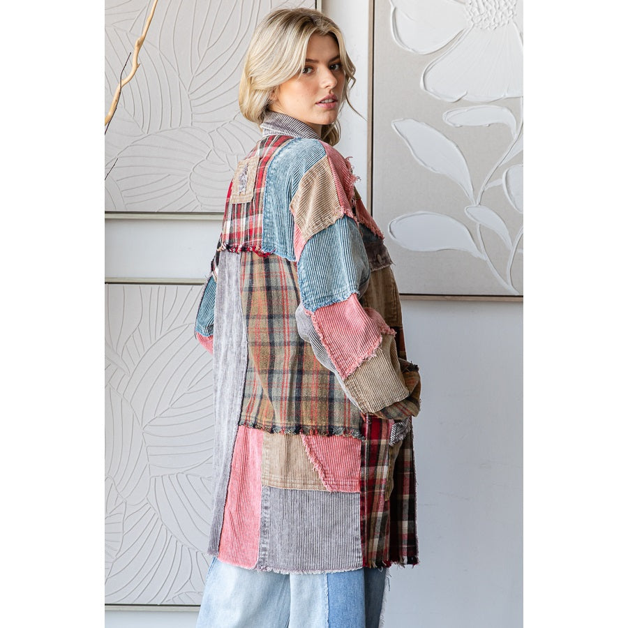 Woman wearing a patchwork jacket in a room with decorative wall art.