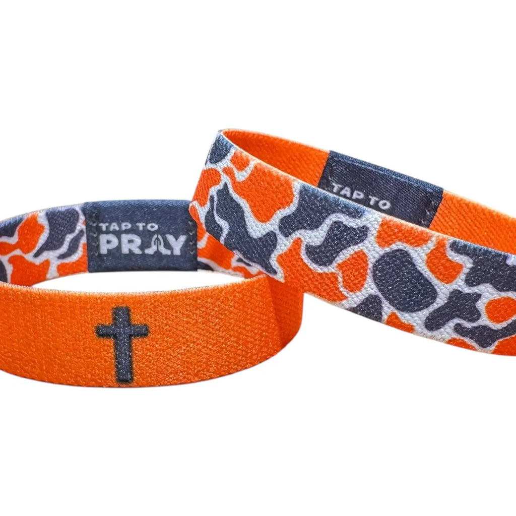 Orange wristband with camouflage pattern and cross symbol on a white background