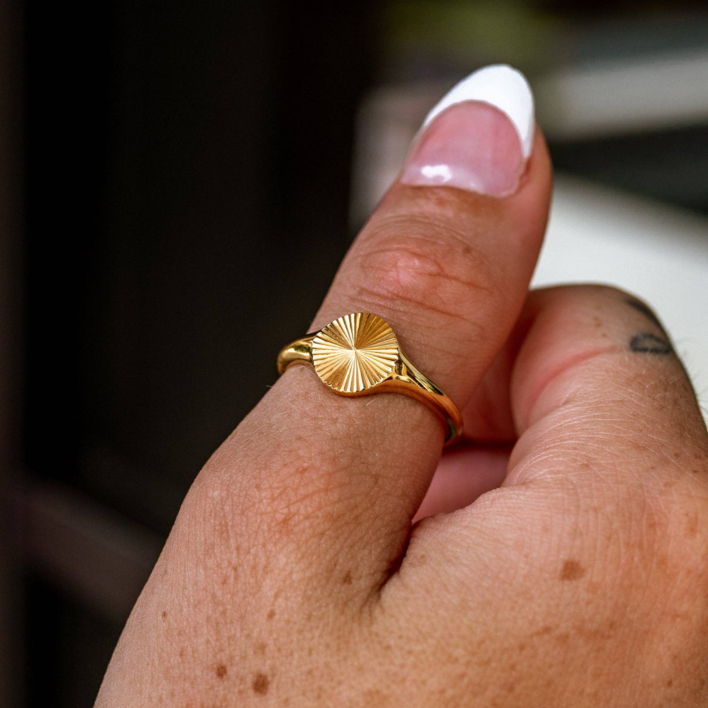 Gold ring on a finger with a blurred background