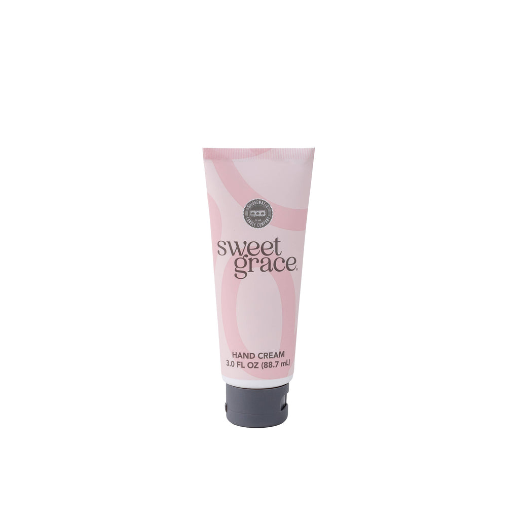 A tube of Sweet Grace hand cream with a pink and white design.