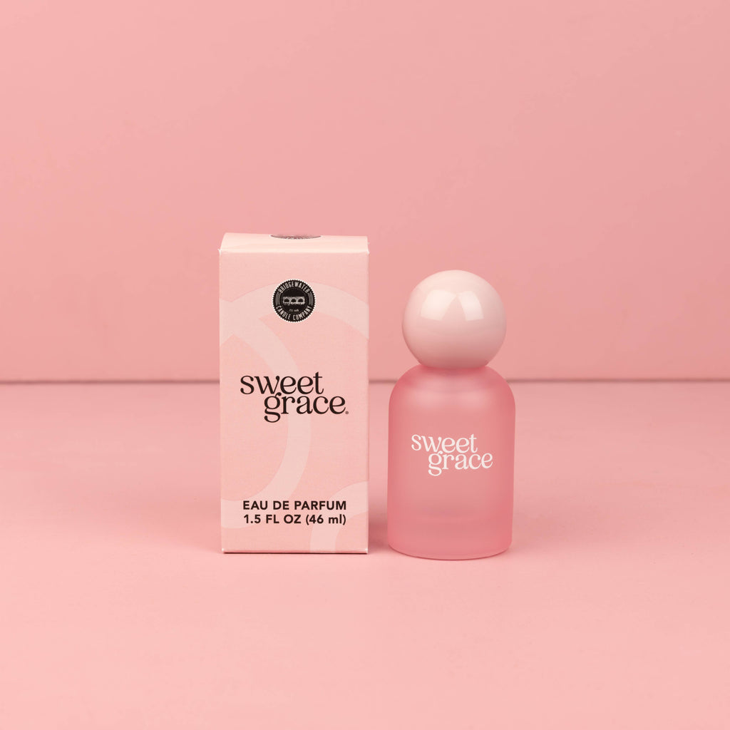 Pink 'sweet grace' eau de parfum bottle and packaging on a pink background