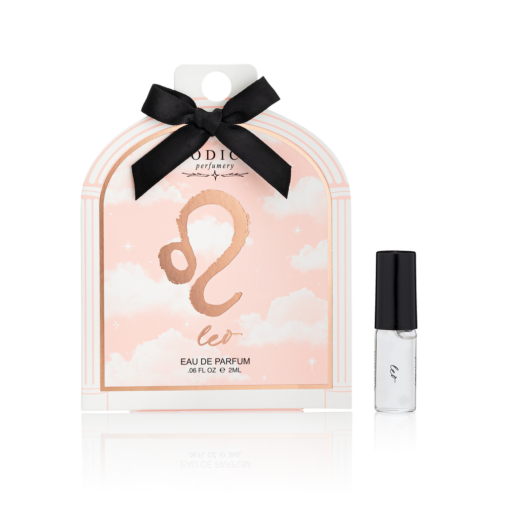 Perfume packaging with a black bow and a small bottle on a white background