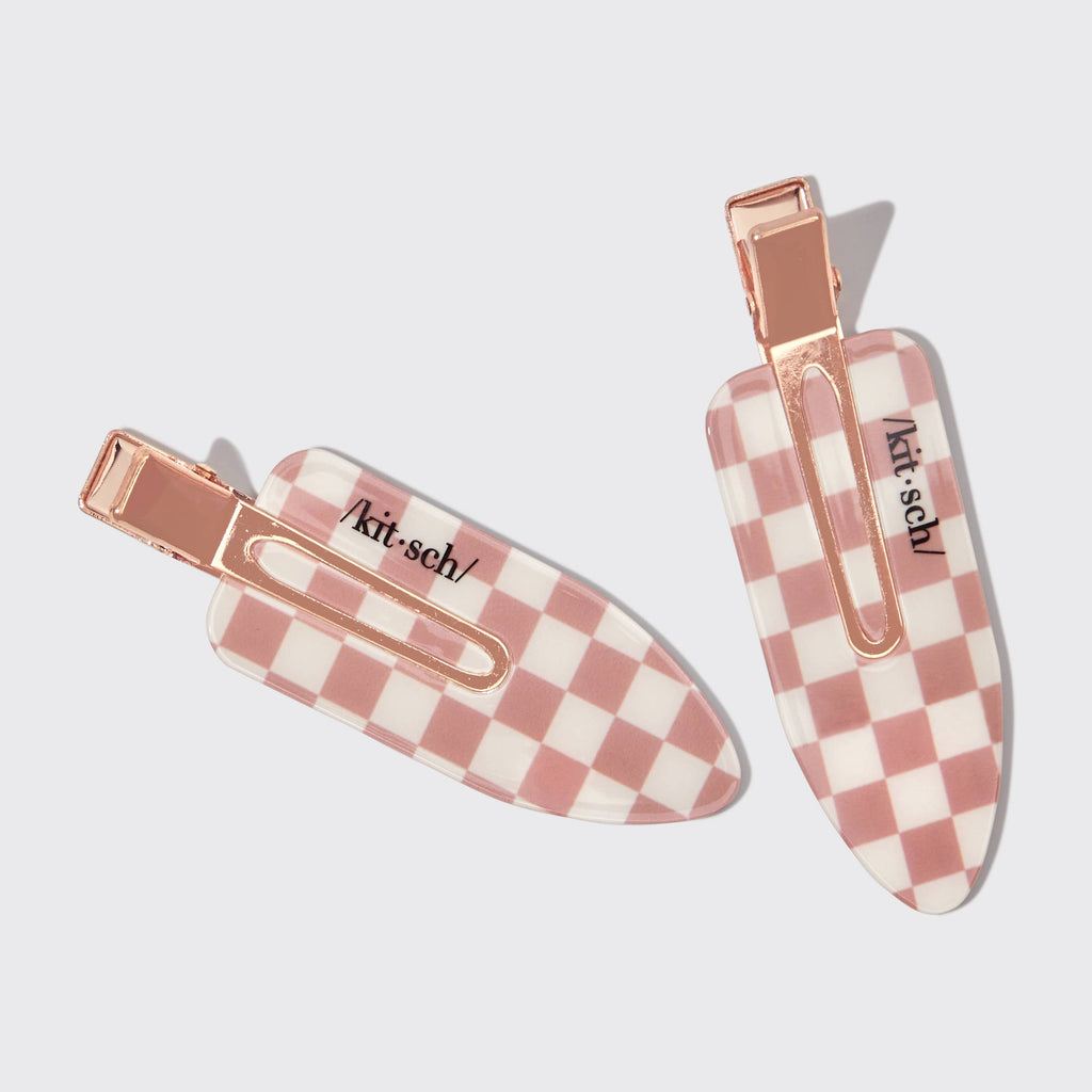 Two checkered hair clips with 'kit-sch' branding on a light gray background