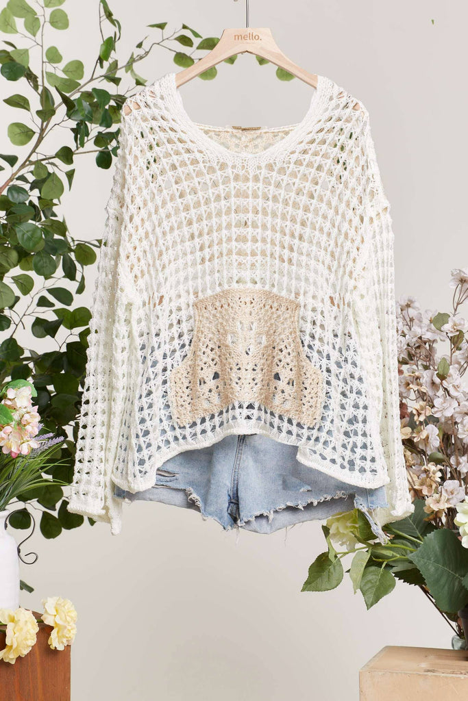 Crocheted top on a hanger with floral decorations