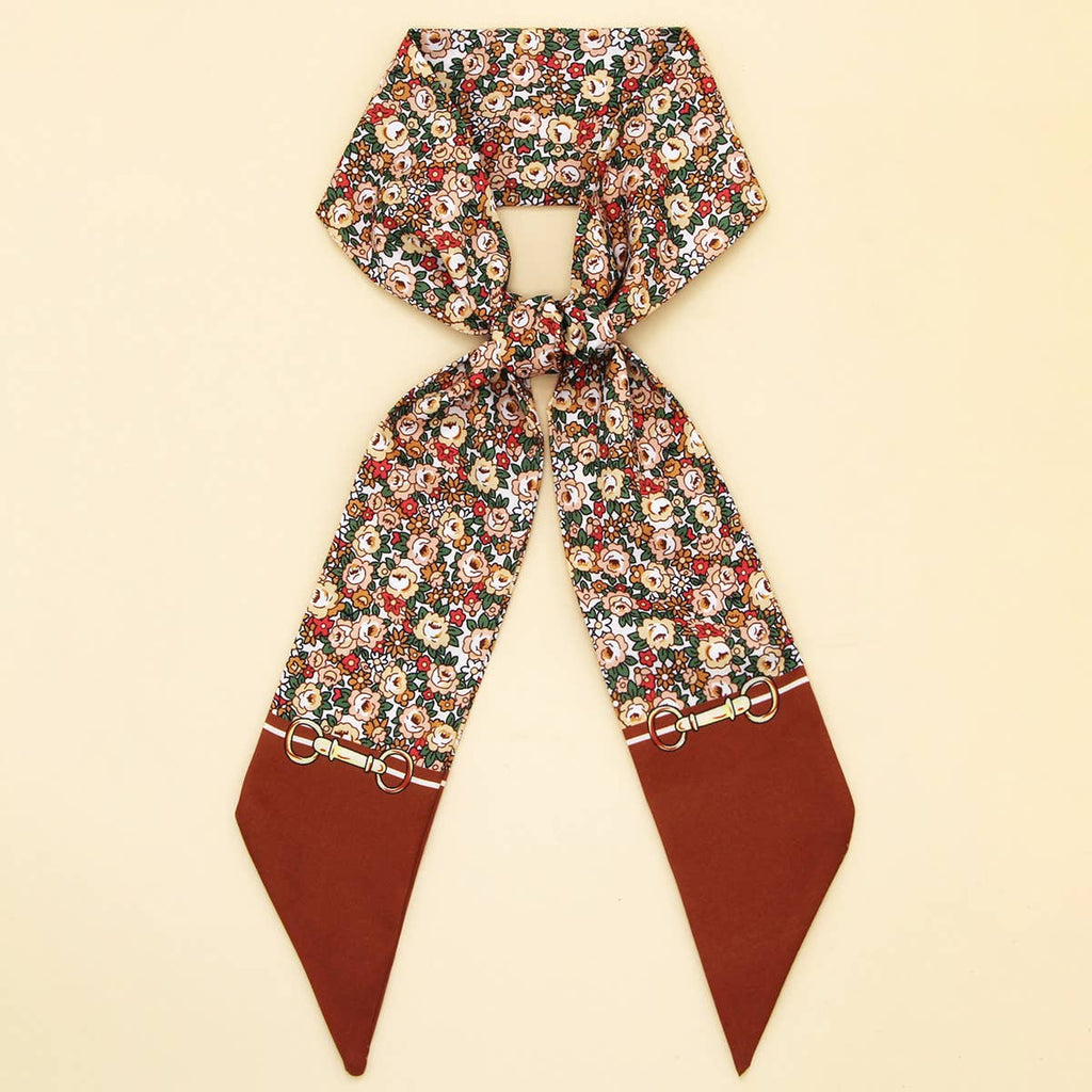 Floral patterned scarf with brown tips on a beige background