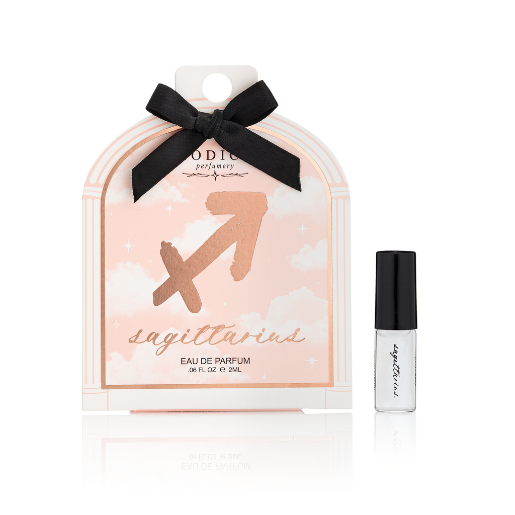 Perfume set with Sagittarius design and black bow on a white background