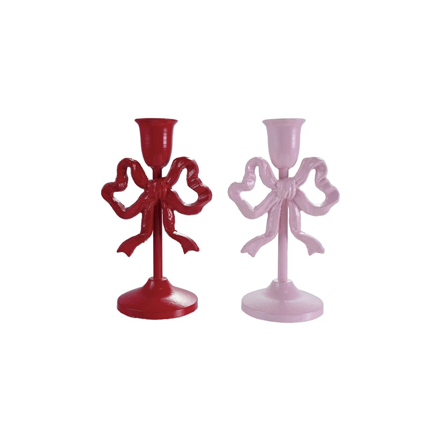Cast iron bow taper candle holders in red (Crimson Ribbon) and pink (Blush Ribbon), sold separately. Perfect for mantel, dining, or romantic home décor.