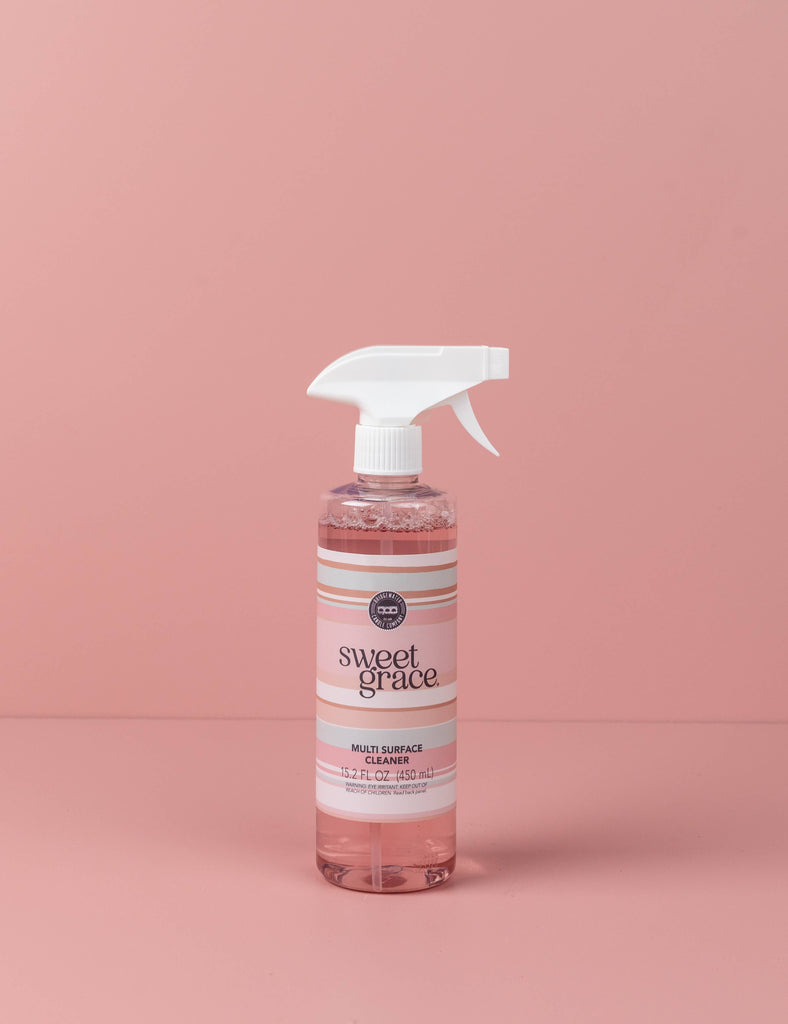 Bottle of Sweet Grace multi-surface cleaner on a pink background