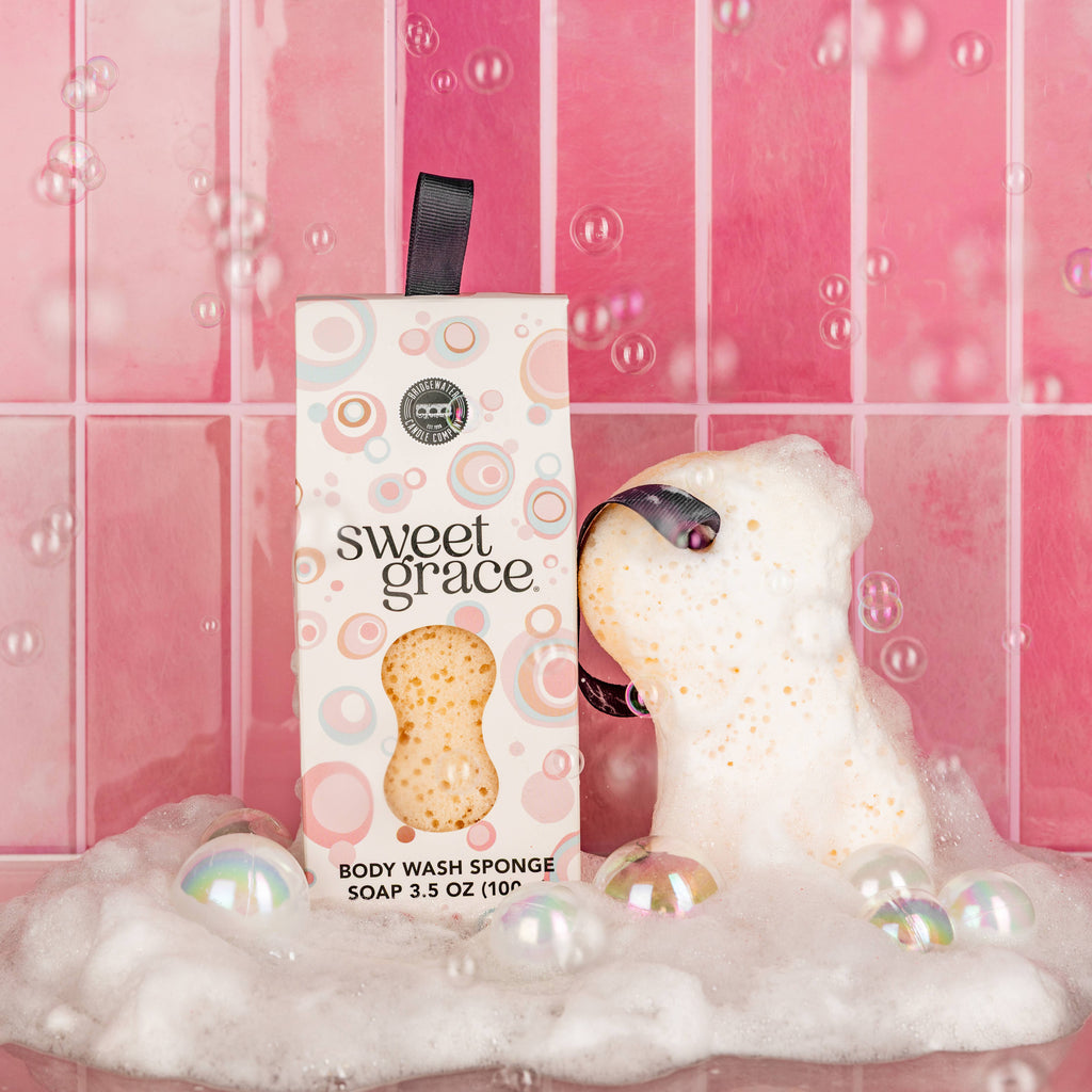 Body wash sponge with packaging labeled 'sweet grace' in a bubble bath setting.